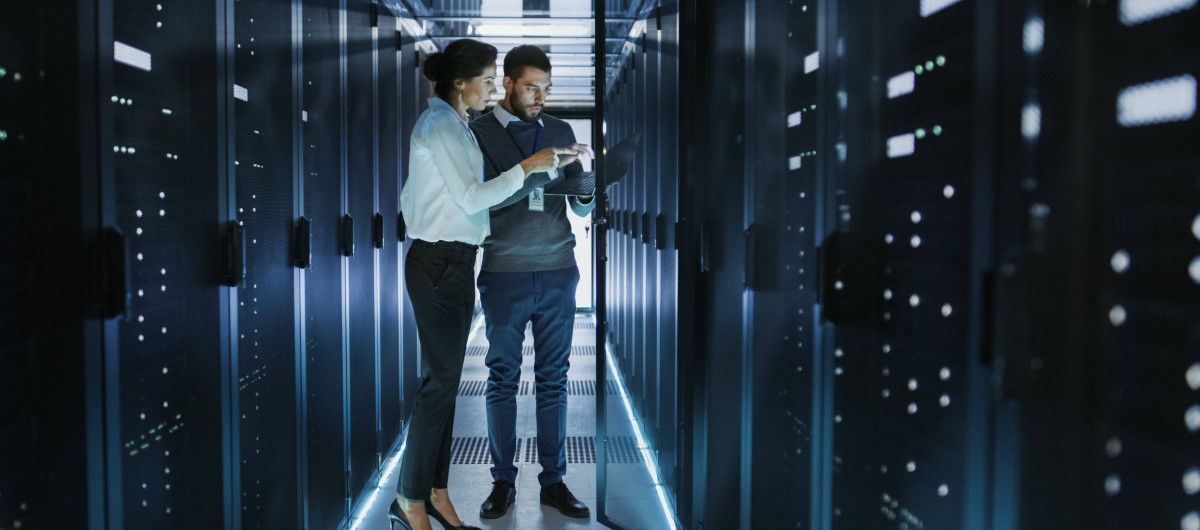 Woman and man working in server room