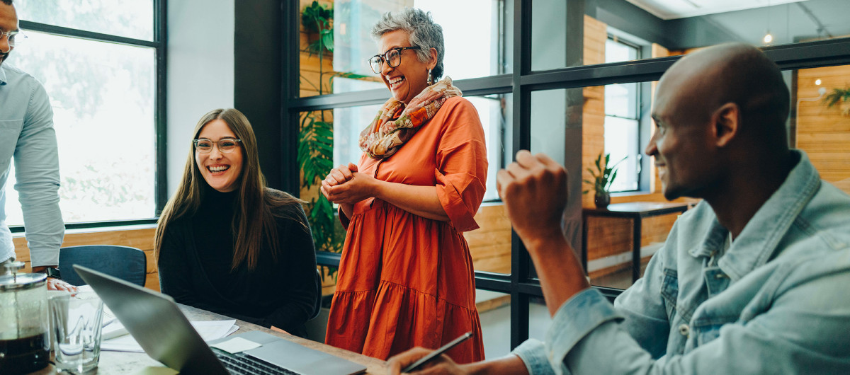 Diverse businesspeople smiling cheerfully during an office meeting