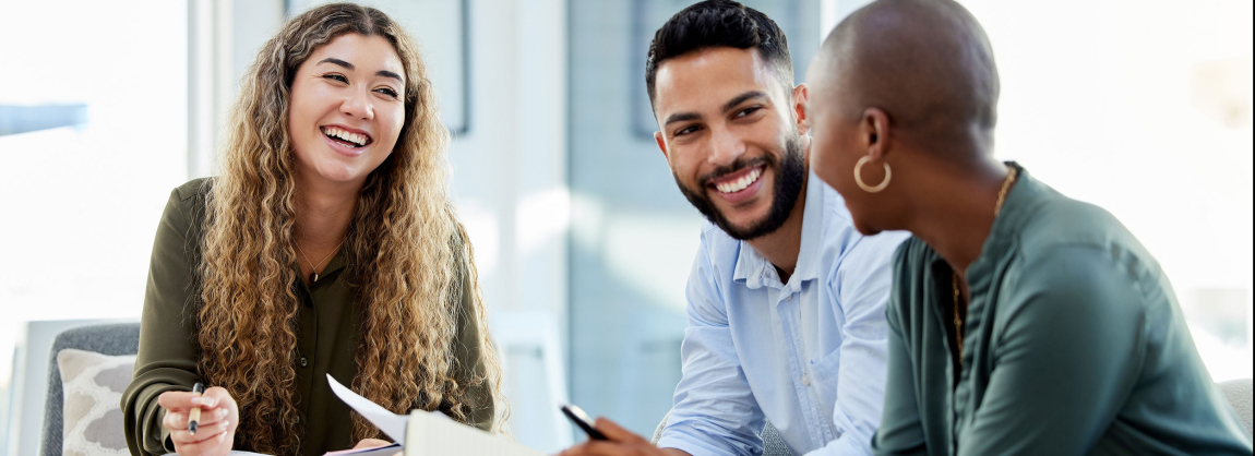 Happy business people smile during a planning meeting. Diversity, collaboration and teamwork in a healthy work environment.