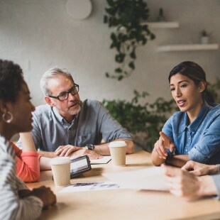 Group of coworkers having a meeting in a cafe