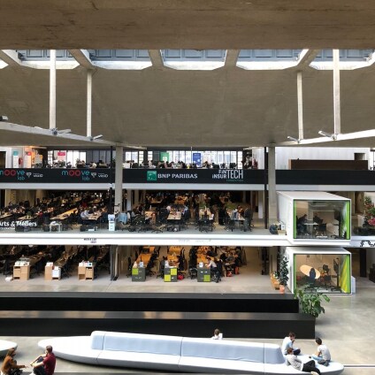 Central hall of startup hub Station F with BNP Paribas logo