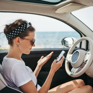 Young driver questions her telephone, summer spirit