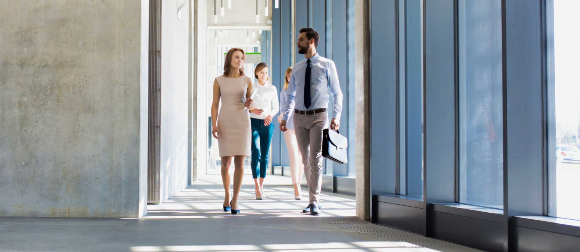 Business people walking in office corridor