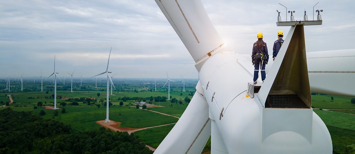 Inspection engineers standing on top of a wind turbine