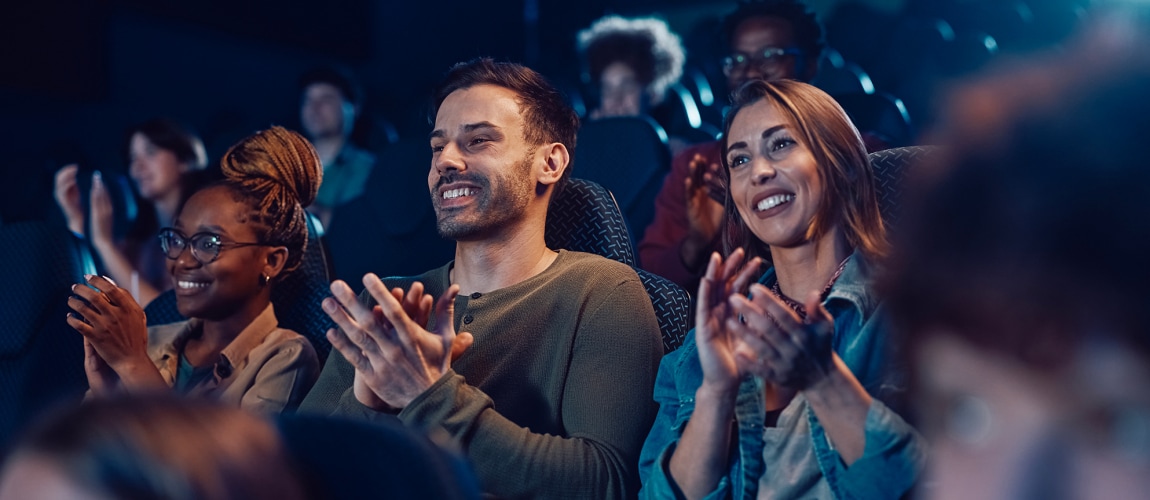 audience applauding after movie premiere at cinema