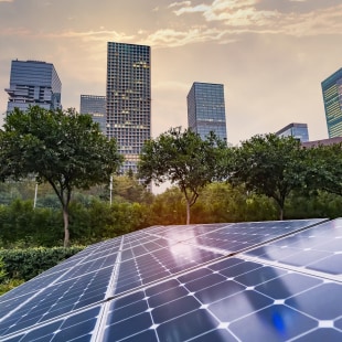 Ecological energy renewable solar panel plant with urban landscape landmarks