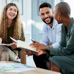 Happy business people smile during a planning meeting. Diversity, collaboration and teamwork in a healthy work environment.
