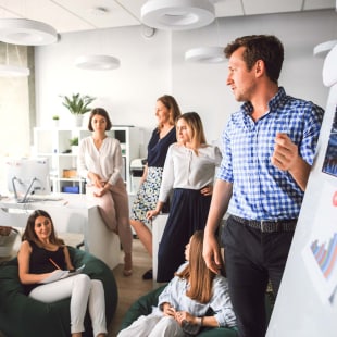 Creative business team in the office listening to the boss.