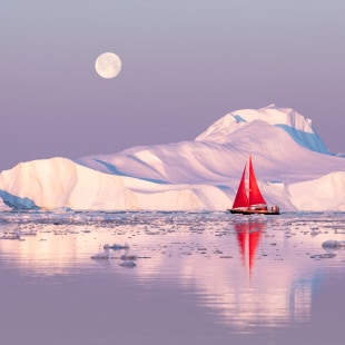 Little red sailboat cruising among floating icebergs in Disko Bay glacier during midnight sun season of polar summer. Ilulissat, Greenland.