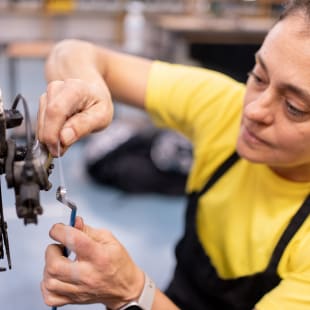 woman fixing bike rear wheel change