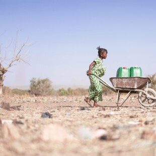 Little African Woman Transporting Fresh Water as a drought symbol
