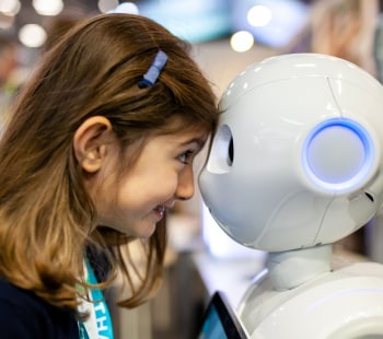 Little girl meets a robot at Vivatech
